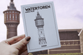 Watertoren Sneek postcard held in front of the tower